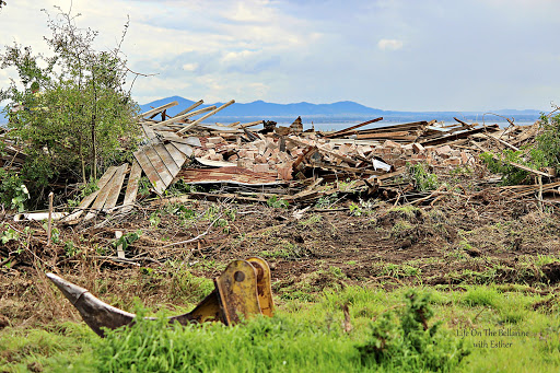 Old Lincoln farm demolished with Bellarine Peninsula setting in background of mountain and water view