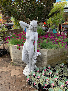 Statue of a naked woman posting in the garden at Van Loons Nursery Victoria