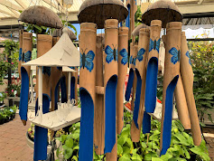 Wooden upcycled wind chimes with blue butterfly painted on them in nursery